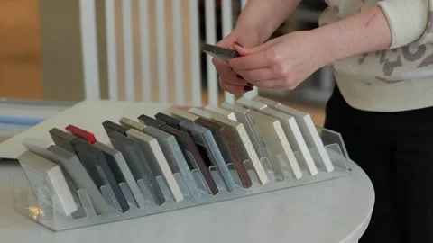 Samples of stone kitchen countertops made of natural stone, a woman picks up the Stock Footage 255232555