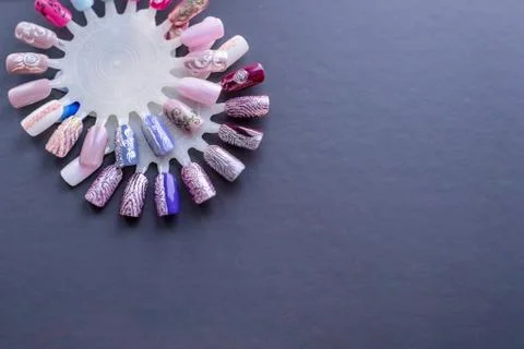Samples of various hand painted fingernail designs isolated on grey. Big choice Stock Photos