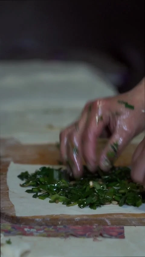 Samsa is made by stuffing greens into thin dough. Stock Footage 310376628