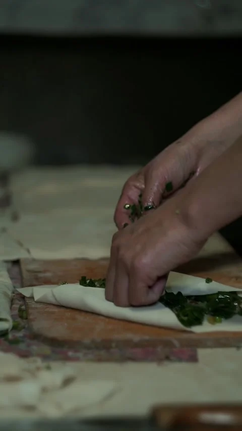 Samsa is made by stuffing greens into thin dough. Stock Footage 310376703