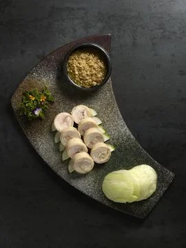 Samsui Ginger Chicken Roll with ginger past and cucumber served in a dish iso Stock Photos