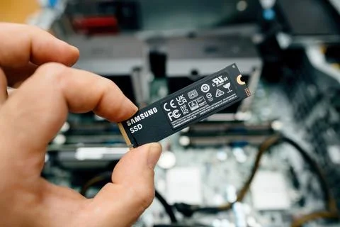 Samsung SSD held above computer components Stock-Fotos
