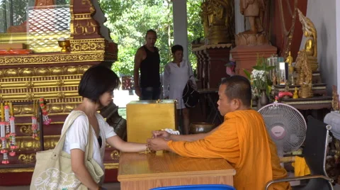 Samui, Thailand - 15 AUGUST 2016: Buddhist monk blessing Thai woman Stock Footage 67660358