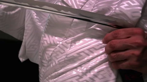 A samurai pulls a samurai sword out of its scabbard Stock Footage 211812300