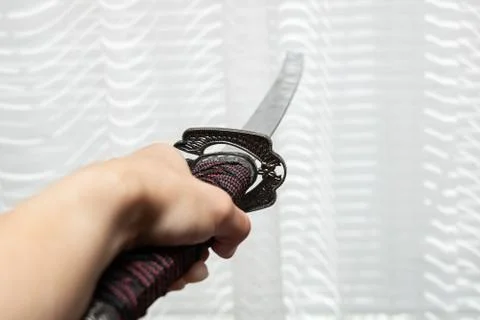 Samurai sword in hand close up, copy space Stock Photos