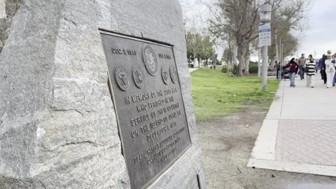 SAN DIEGO, CA - MARCH 12, 2025 - Stone war memorial plaque near marina Stock Footage 345265557