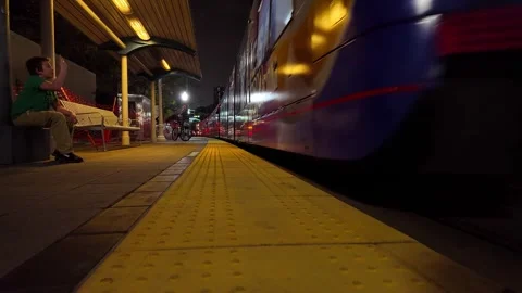 San Diego trolley arriving at an empty station platform during a quiet urban Stock Footage 337605274