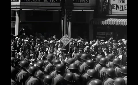 SAN FRANCISCO - 1945 - Spectators crowd a street and roof tops in a street to Stock Footage 308102658