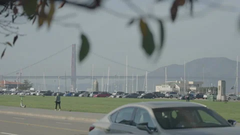 San Francisco, CA - Dec 15, 2024: Bridge background, car parking middle ground Stock Footage 333580780