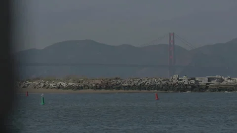 San Francisco, CA - Dec 15, 2024: Bridge background, stone wall,ocean foreground Stock Footage 333580790