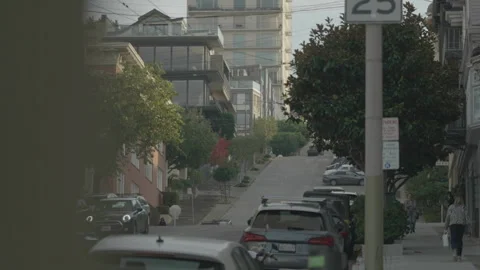 San Francisco, CA - Dec 15, 2024: Steep street with cars driving and foreground Stock Footage 333580809