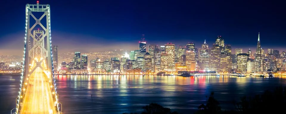 San Francisco city lights and Bay Bridge at night Stock Photos
