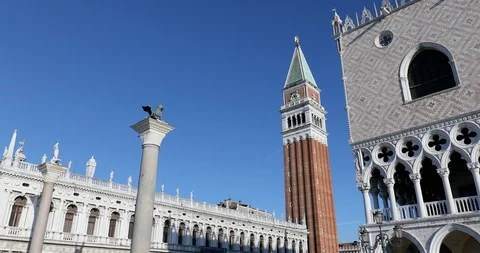 San Marco square with lion statue on column and bell tower tilt view in Italy Stock Footage 129295089