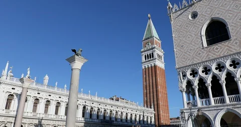 San Marco square with lion statue on column and bell tower tilt view in Italy Stock Footage 129295133