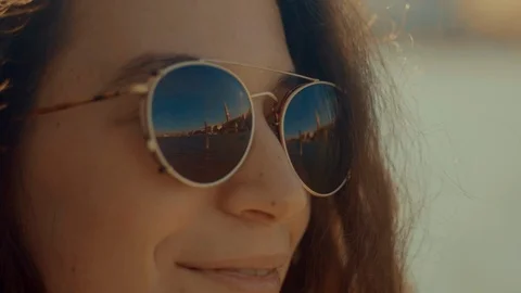 San Marco square is seen reflected in the sunglasses of a young woman in Venice Stock Footage 103356557