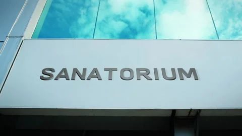 Sanatorium Sign on Modern Building with Cloud Reflection on Windows Glass Stock Footage 303567309
