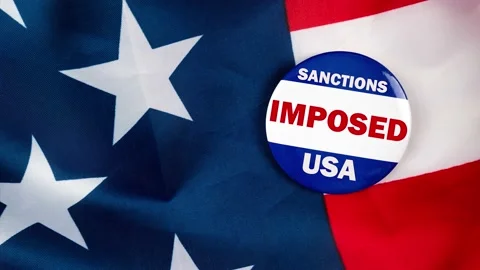 Sanctions imposed usa text on campaign button laying on the american flag. Fr Stock Footage 170943834