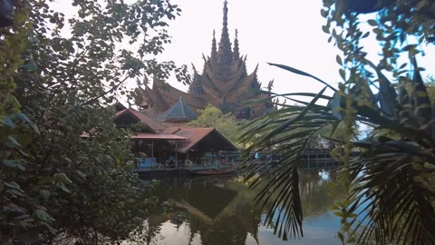 The Sanctuary of Truth Museum seen trough vines at riverbank. largest wooden Vidéo 343400741