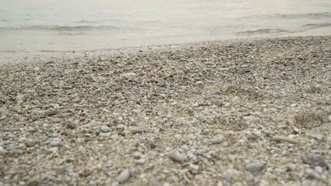 Sand and pebbles beach with ripple wave sea Stock Footage 235583597