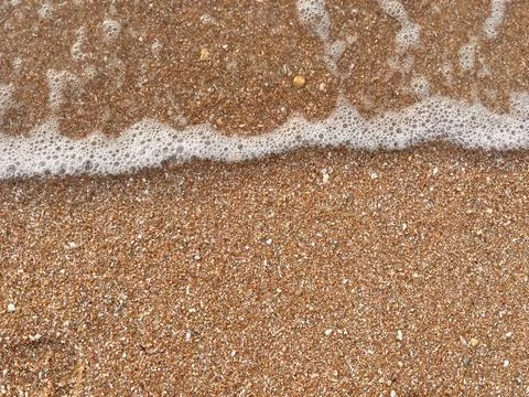 Sand and wave background Stock Photos
