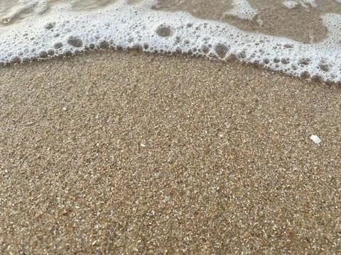 Sand and wave background Stock Photos