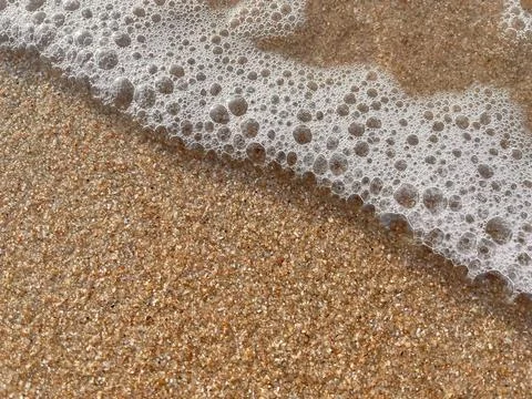 Sand and wave background Stock Photos
