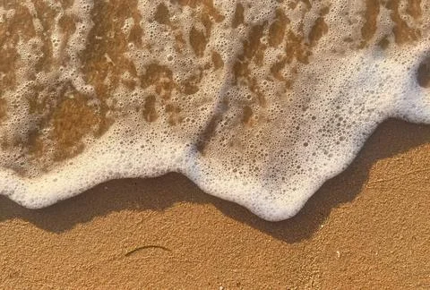Sand and wave background Stock Photos