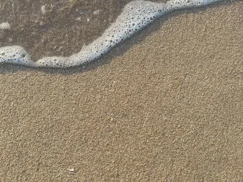 Sand and wave background Stock Photos