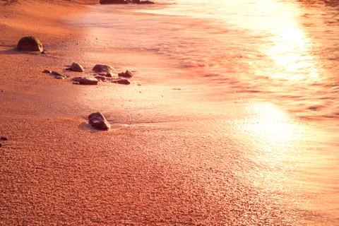 Sand and waves Stock Photos