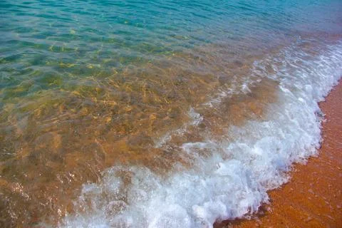 Sand and waves Stock Photos