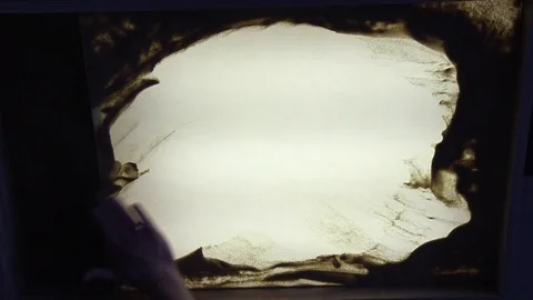 Sand animation. Child drawing sand on a white screen with hands Stock Footage 123647299