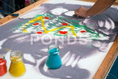 Sand animation, drawing sand closeup, girl draws a Christmas tree on the sand Stock Photos
