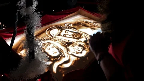Sand artwork drawing on lightning transparent glass surface, holy jesus Stock Footage 121863427