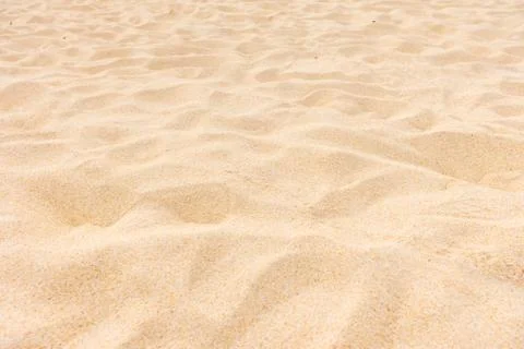 Sand background on the beach in summer sun Stock Photos