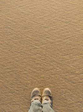 Sand background with boots Stock Photos