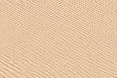 Sand background. Desert dune texture. Sandy beach. Stock Photos