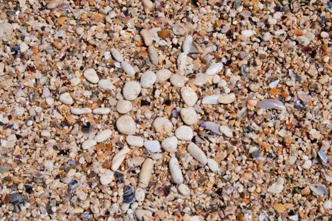 Sand background with sun from pebble Stock Photos