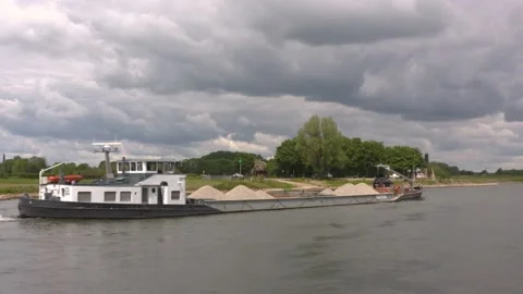 Sand barge sailing downstream the river IJssel (rear - view downstream) Stock Footage 130644799