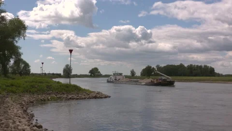 Sand barge sailing downstream the winding river IJssel Stock Footage 130644705