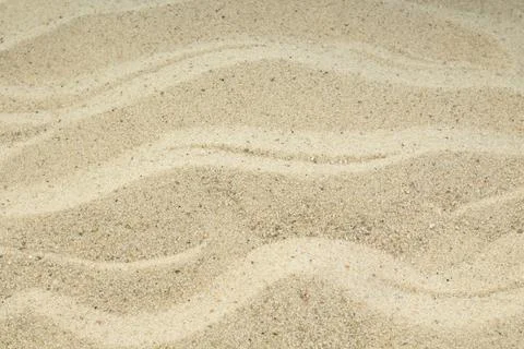 Sand on the beach as background. Concept of rest. Top view. Stock Photos