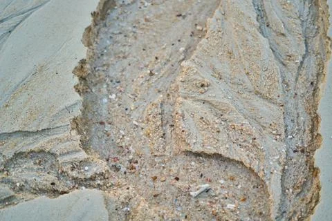 Sand on the beach background traces left on the sand after the tide Stock Photos