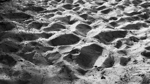 Sand on the beach close-up black and white. Summer time. Daylight. Abstract Stock Footage 238703062