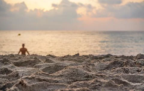 Sand on beach, closeup low angle detail, blurred person in background ready.. Stock Photos