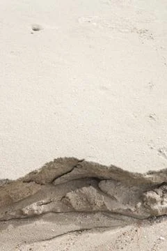 Sand on the beach that has been eroded by ocean waves. Photos