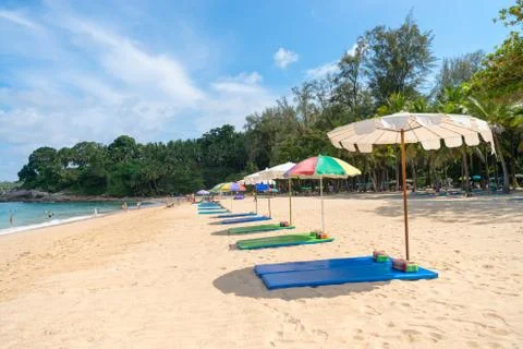 Sand beach with line of empty sunbeds and parasol sunshade Stock Photos