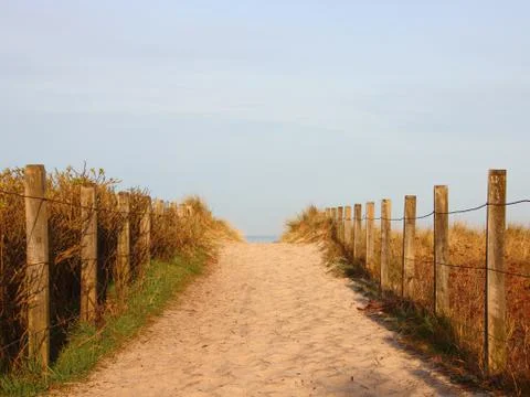 Sand Beach Path Towards Ocean with Fence Foto stock