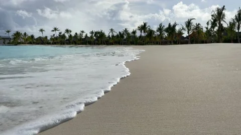 Sand beach sea tide waves on tropical paradise island in maldives Stock Footage 201031944