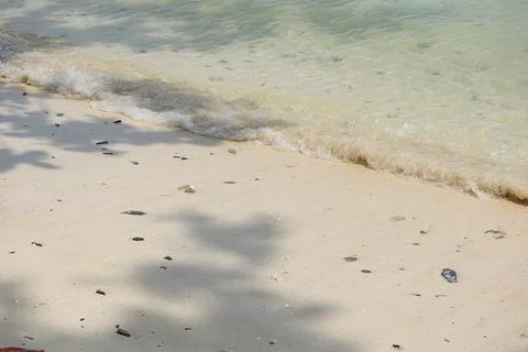 Sand beach with sea waves Stock Photos