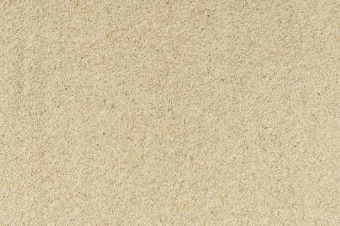 Sand beach texture background. Light hot sand on the sea coast in summer. Stock Photos