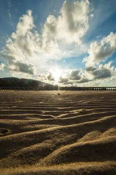 Sand beach texture at sunset Stock Photos